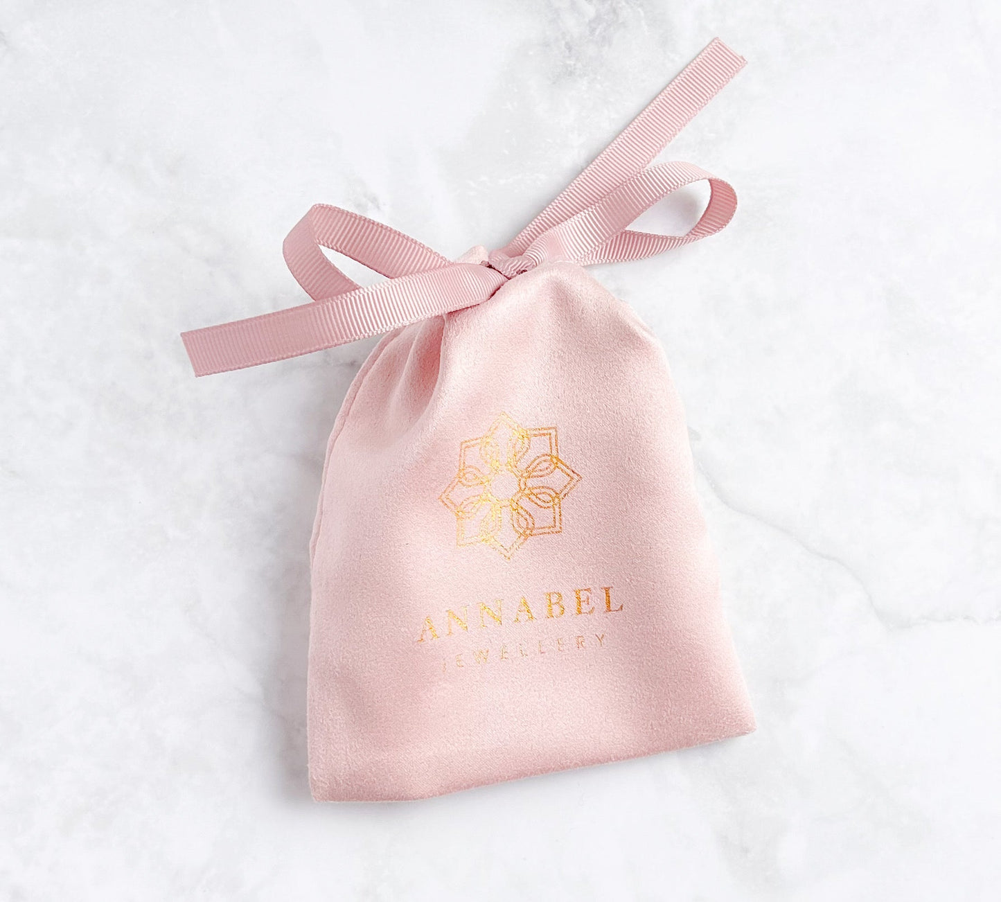 a pink pouch with the annabel jewellery logo